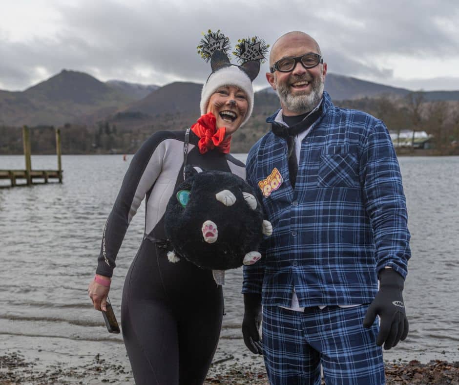Couple dressed in fancy dress over wetsuits for our festive New Year's Day dip