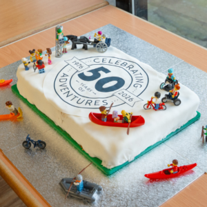 Birthday cake with 50th decal on top and inclusive lego figures decorating the icing