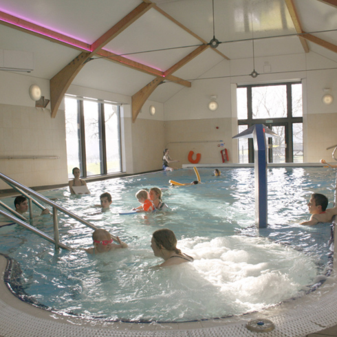 Lots of people of all ages in the swimming pool
