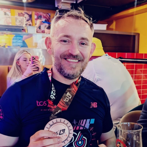 Man with medal after running the London Marathon in 2026