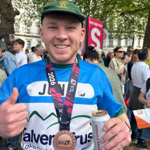 Man with medal after running the London Marathon in 2026