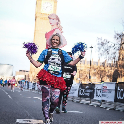 Woman with pom poms running the London Marathon in 2026