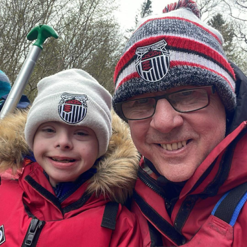 Selfie of a father and son in red waterproof sailing gear