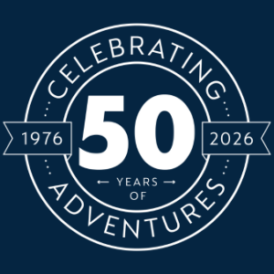 Logo for 50th anniversary in white with blue background saying 'Celebrating 50 years of adventures'