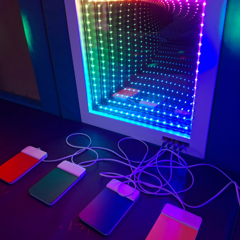Light tunnel sensory room toy with coloured paddle controls in front