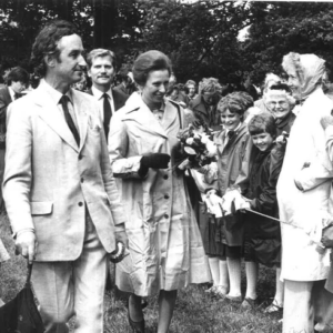 A man guiding a woman through a crowd of people