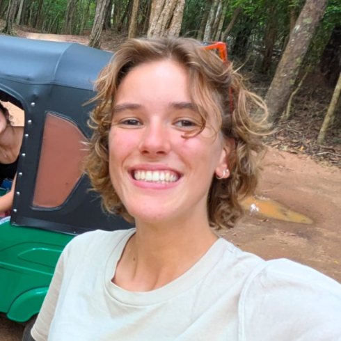 Selfie of a young woman in front of a tuk tuk