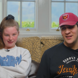 Man and woman sitting next to each other on a sofa